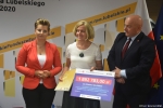 Przekazanie czeków na realizację działań związanych z przeciwdziałaniem skutkom rozprzestrzeniania się pandemii Covid-19 w domach pomocy społecznej. Od lewej: zastępca dyrektora ROPS Marta Drozd, dyrektor PCPR w Białej Podlaskiej Małgorzata Malczuk trzyma czek z wypisaną kwotą dofinansowania, Marszałek Jarosław Stawiarski