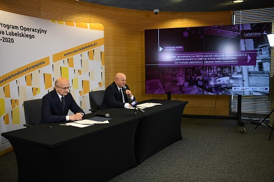 Zdjęcie przedstawia dwóch mężczyzn siedzących przy stole konferencyjnym i udzielających wywiadu. Pierwszy z nich to Prezydent miasta Lublina Krzysztof Żuk a drugi to marszałek województwa lubelskiego Jarosław Stawiarski