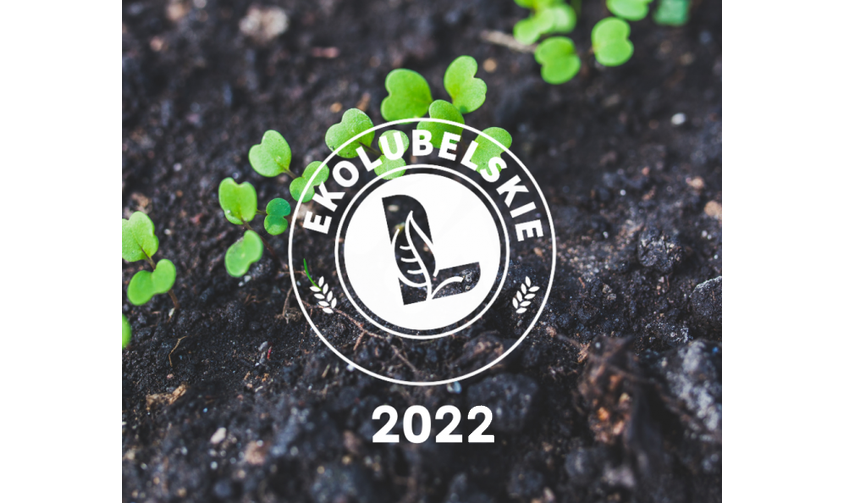 Zdjęcie przedstawiające logo Ekolubelskie 2022 na tle ziemi z kiełkującymi roślinami