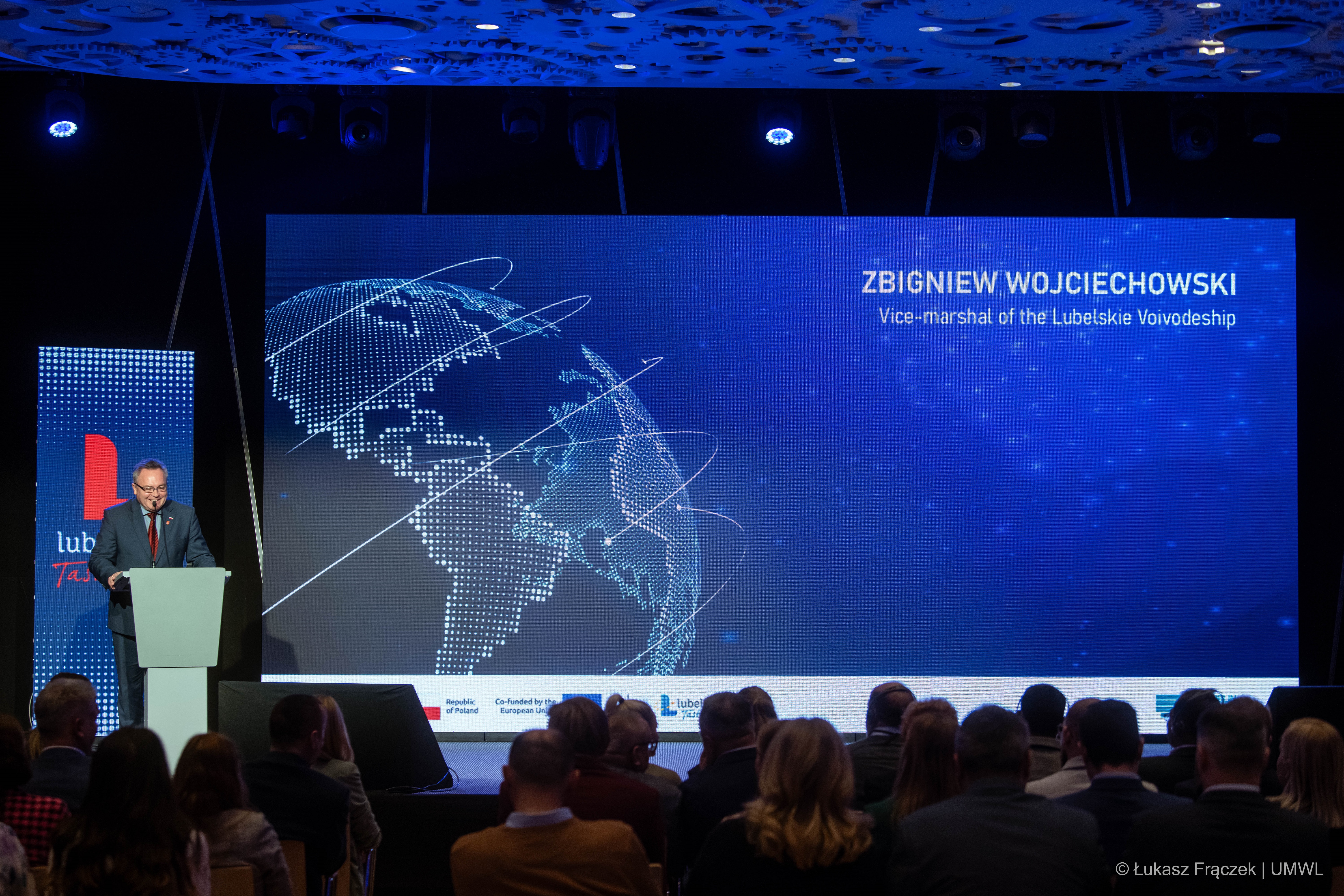 Wicemarszałek Zbigniew Wojciechowski na scenie otwiera spotkanie z delegacją ze Zjednoczonych Emiratów Arabskich