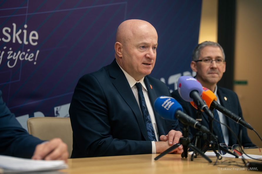 Marszałek Województwa Lubelskiego Jarosław Stawiarski siedzi przy mikrofonie i udziela wypowiedzi podczas konferencji