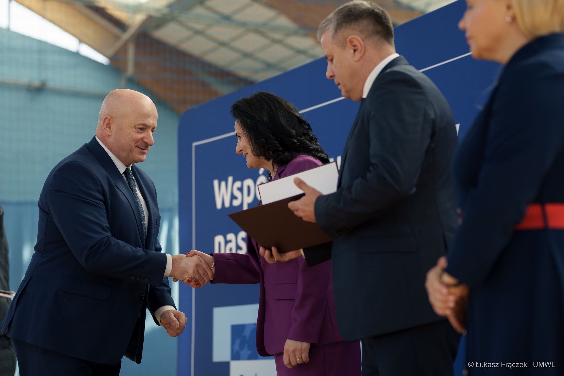 Marszałek Jarosław Stawiarski skłąda gratulacje jednej z beneficjentek programu